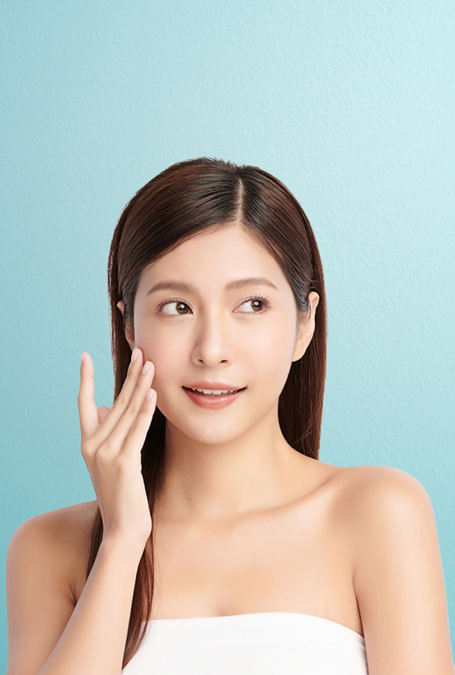 Woman looking to the side with her mouth parted open slightly, wearing makeup 